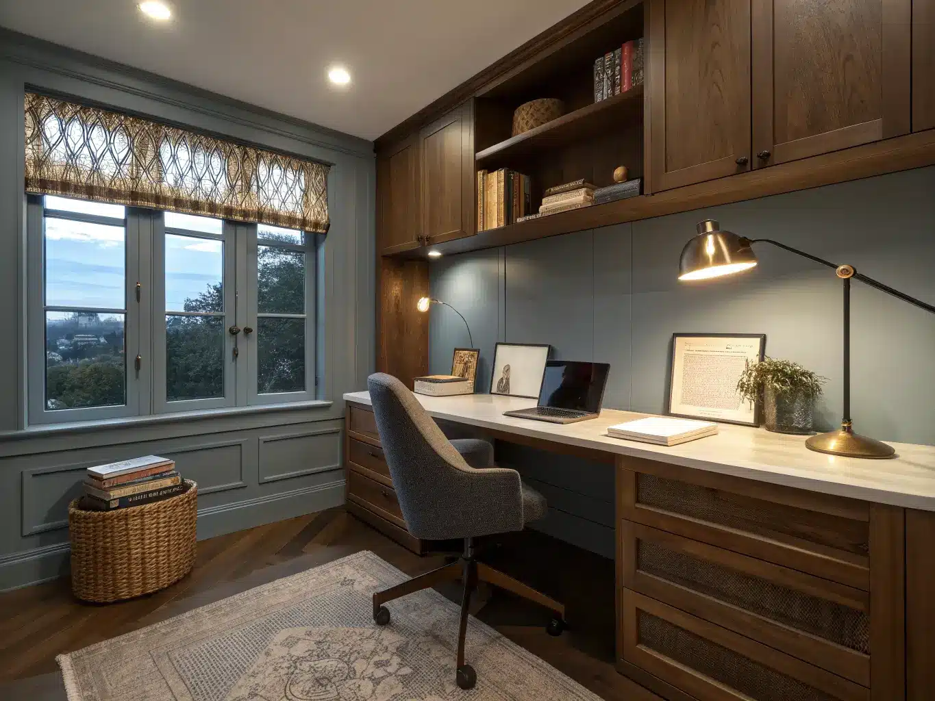 Study room at dusk with recessed ambient light, brass task lamp over an open notebook, LED strip on a walnut shelf, blue-gray walls, walnut desk, and charcoal ergonomic chair.