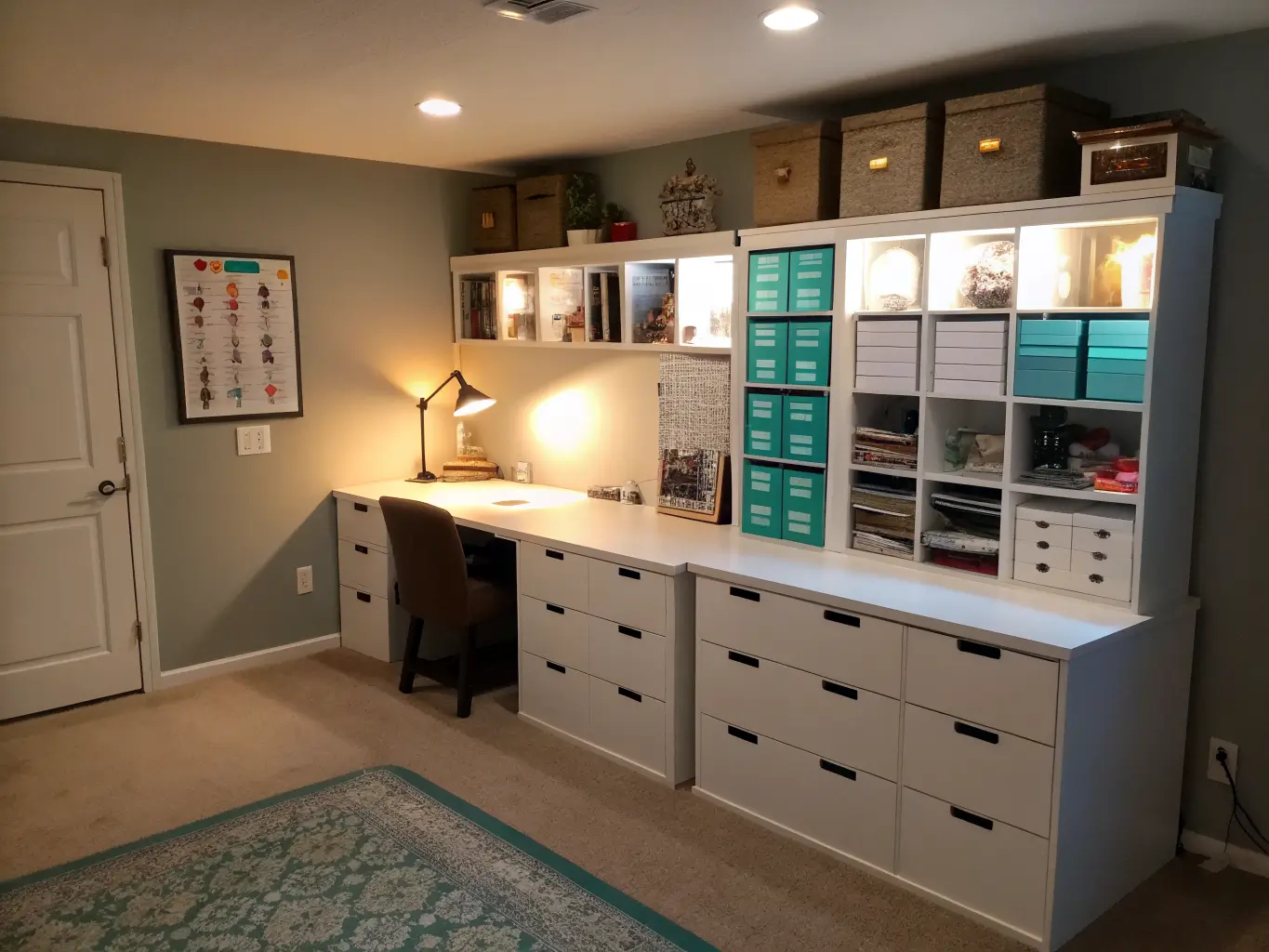 Wide three-quarter view of a basement craft room corner with KALLAX shelves, a white desk with drawers, and warm LED under-shelf lighting illuminating fabric, paper, and organized bins in dim evening light.